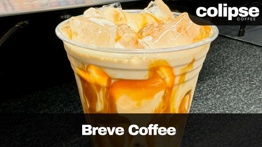 Breve coffee with caramel drizzle in a clear cup, branded 'Colipse Coffee'.
