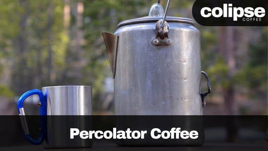 Percolator coffee setup with a metal cup outdoors, featuring Colipse Coffee branding.