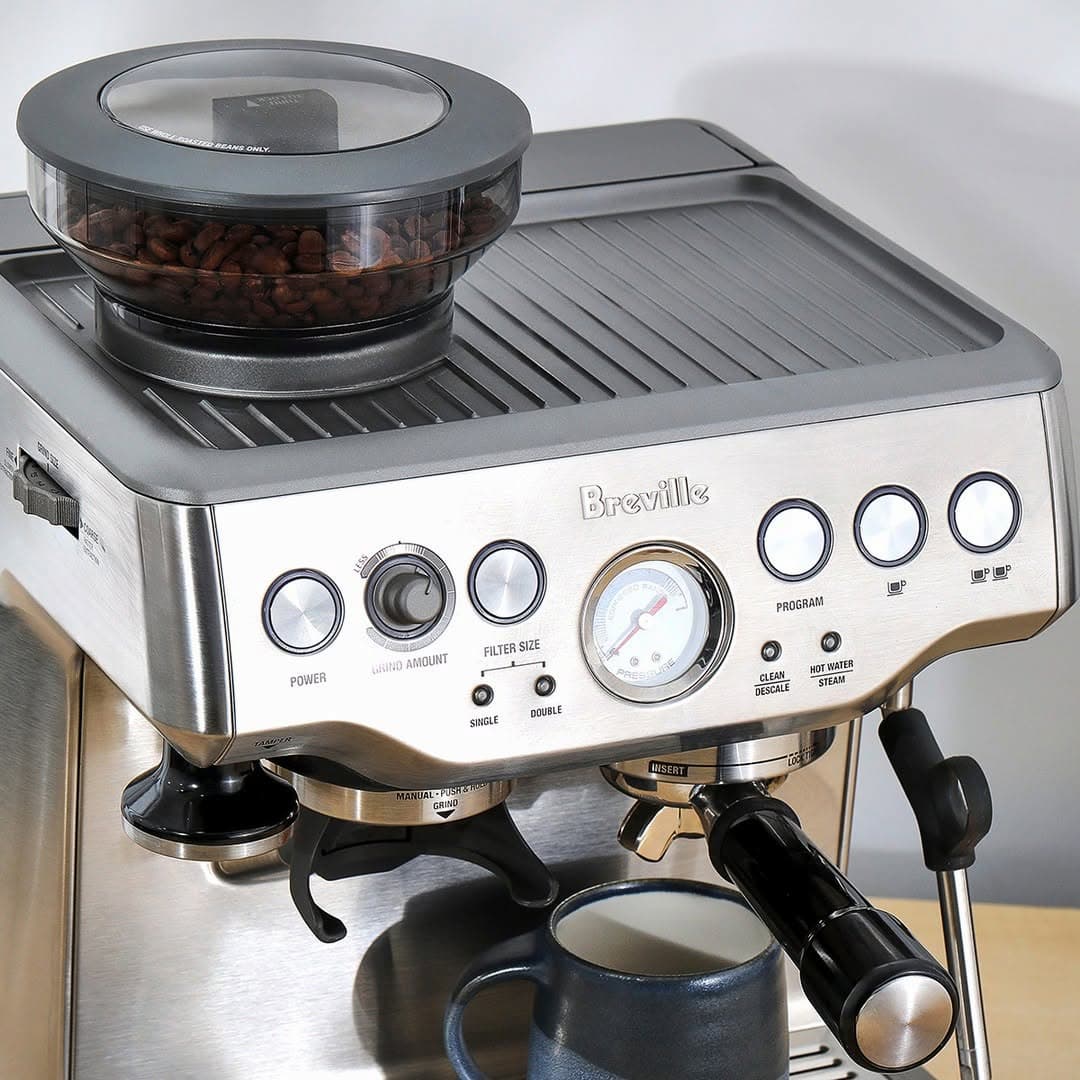 Breville coffee machine with a mug on a wooden surface