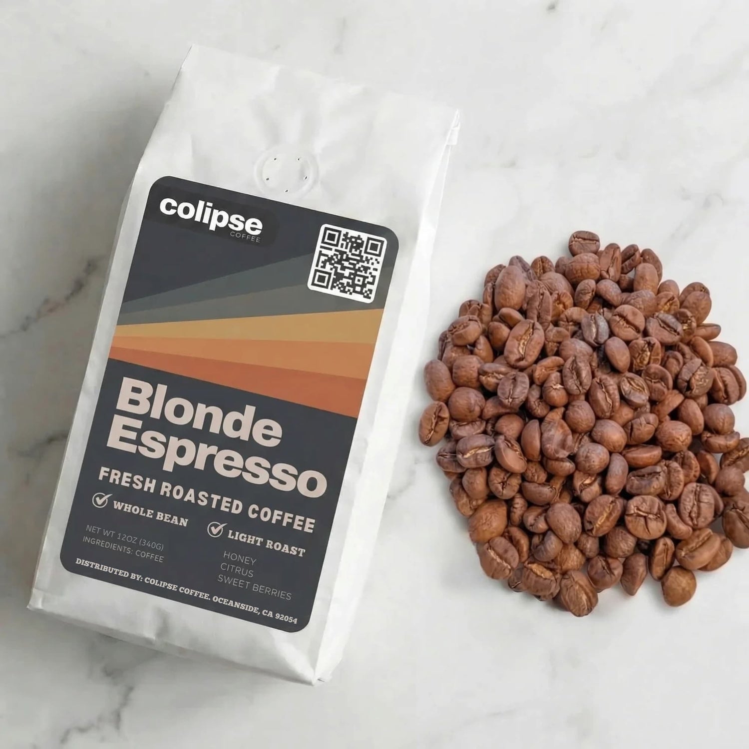 Colipse Blonde Espresso coffee package with coffee beans on a marble surface