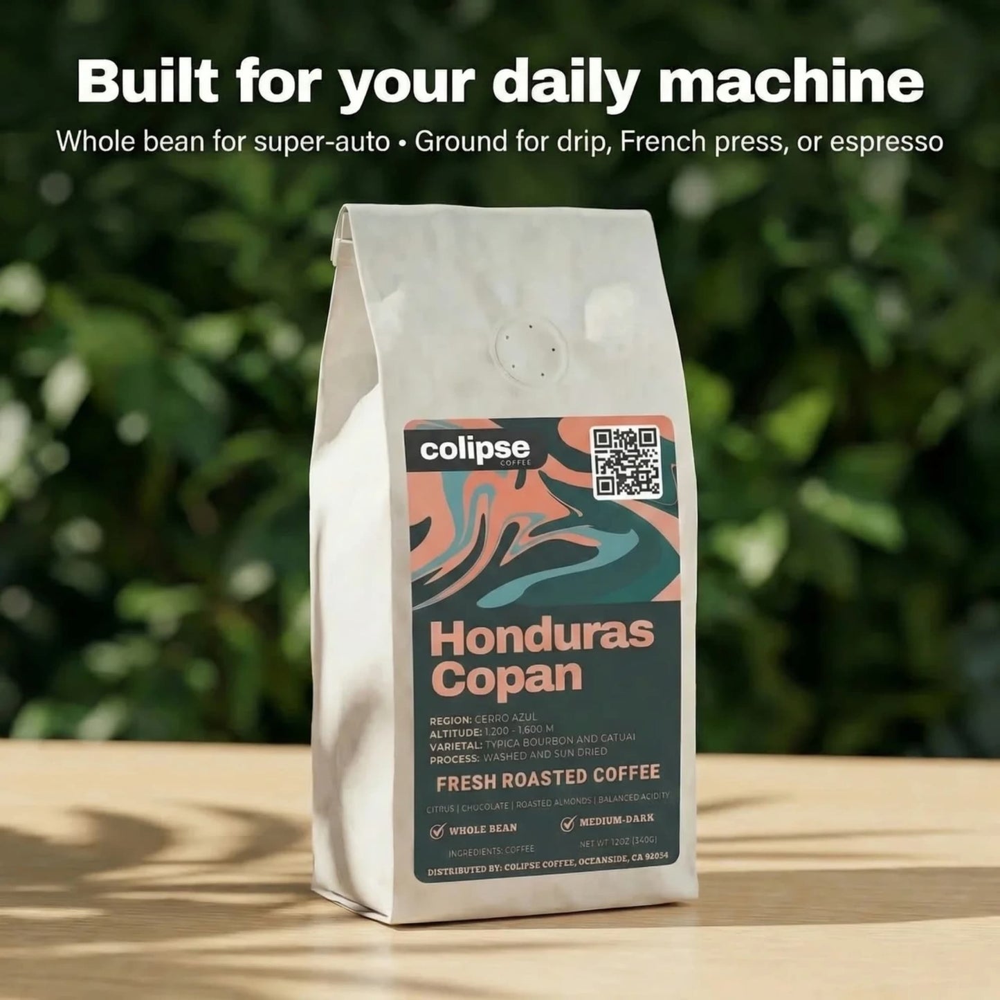 Coffee bag labeled 'Colipse Honduras Copan' on a wooden surface with a blurred green background