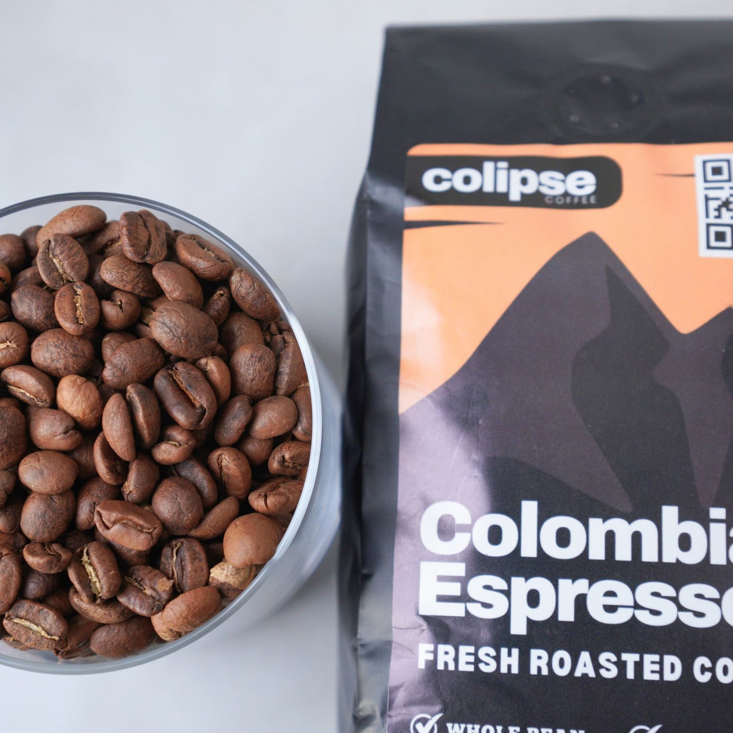 Colipse Coffee Colombian Espresso package with a bowl of coffee beans on a white background