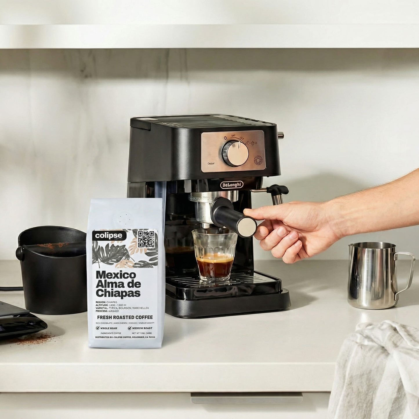 Person using a coffee machine with a bag of Colipse Mexico Alma de Chiapas coffee on a kitchen counter.
