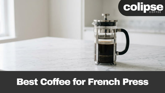 A glass French press filled with dark coffee sits on a light marble countertop in a bright kitchen setting. A black banner at the bottom reads 'Best Coffee for French Press' and the top-right corner shows the 'colipse COFFEE' logo.