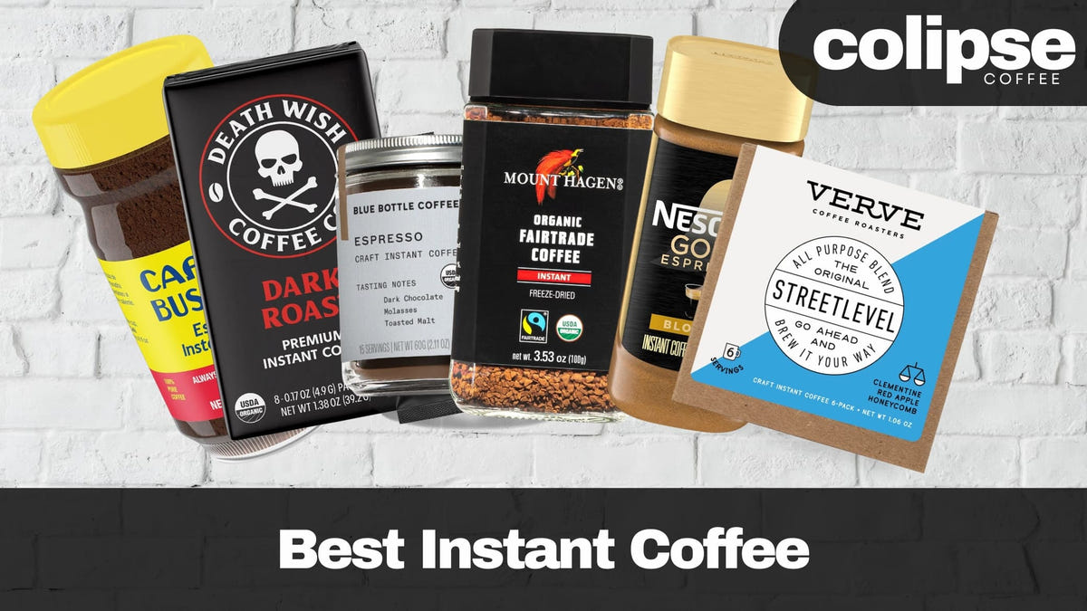 Collection of various instant coffee products with visible brand names on a white brick wall background.