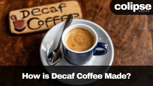 Decaf coffee cup on a wooden surface with 'colipse coffee' branding.