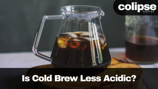Cold brew coffee in a glass carafe with ice cubes, featuring Colipse Coffee branding.