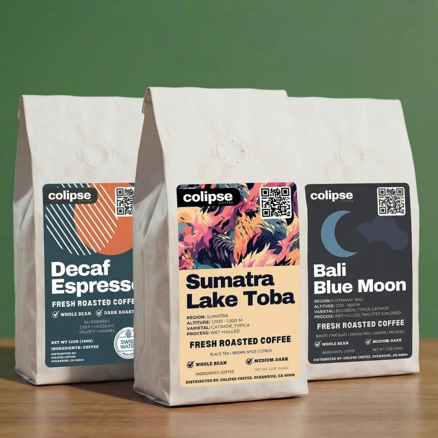 Three low acid colipse coffee bags with different flavors on a wooden surface and green background