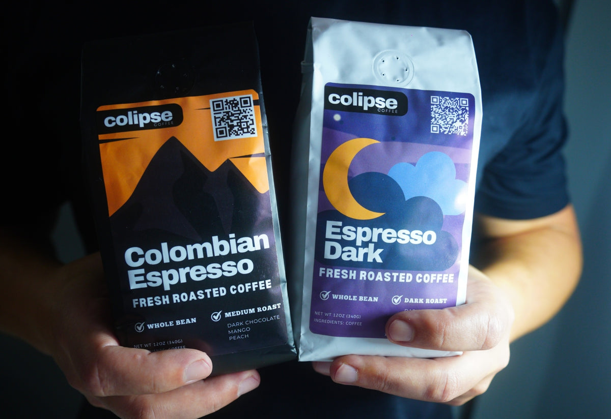 Two coffee packages from Colipse held in hands against a dark background