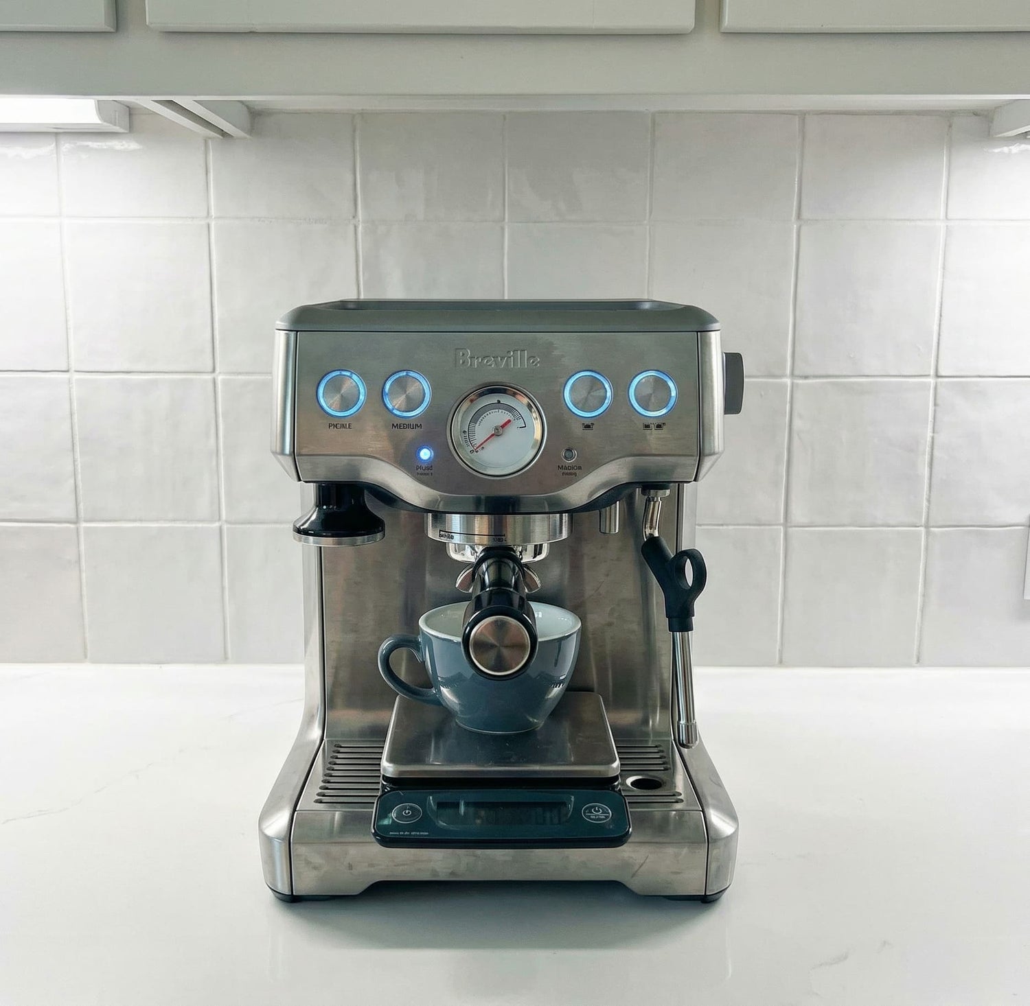 Espresso machine with a cup on a kitchen counter