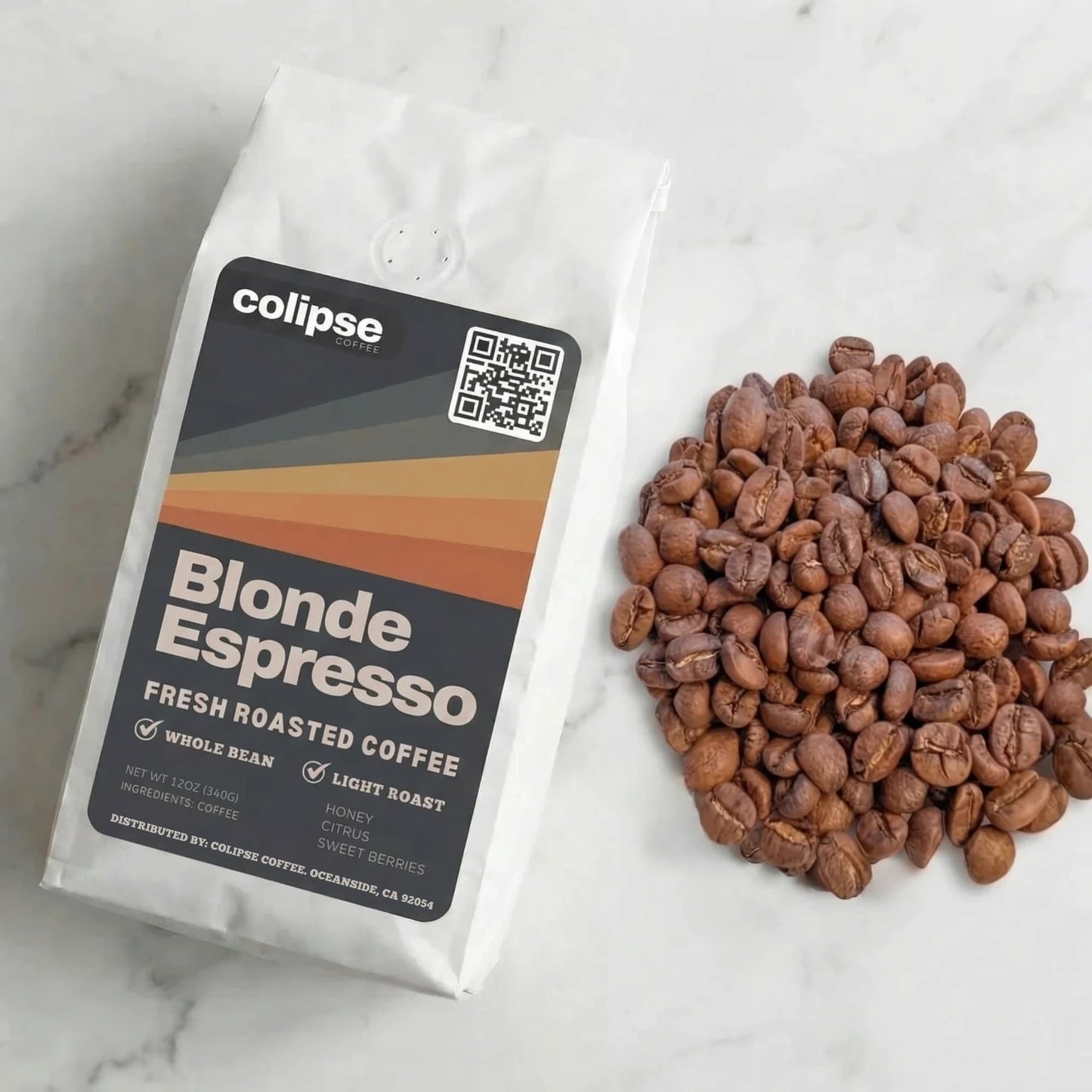 Colipse Blonde Espresso coffee package with coffee beans on a marble surface