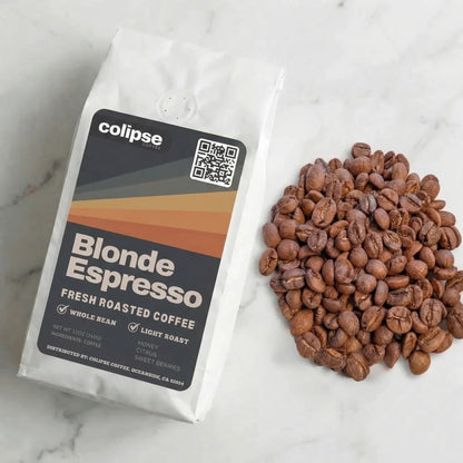 Colipse Blonde Espresso coffee package with coffee beans on a marble surface