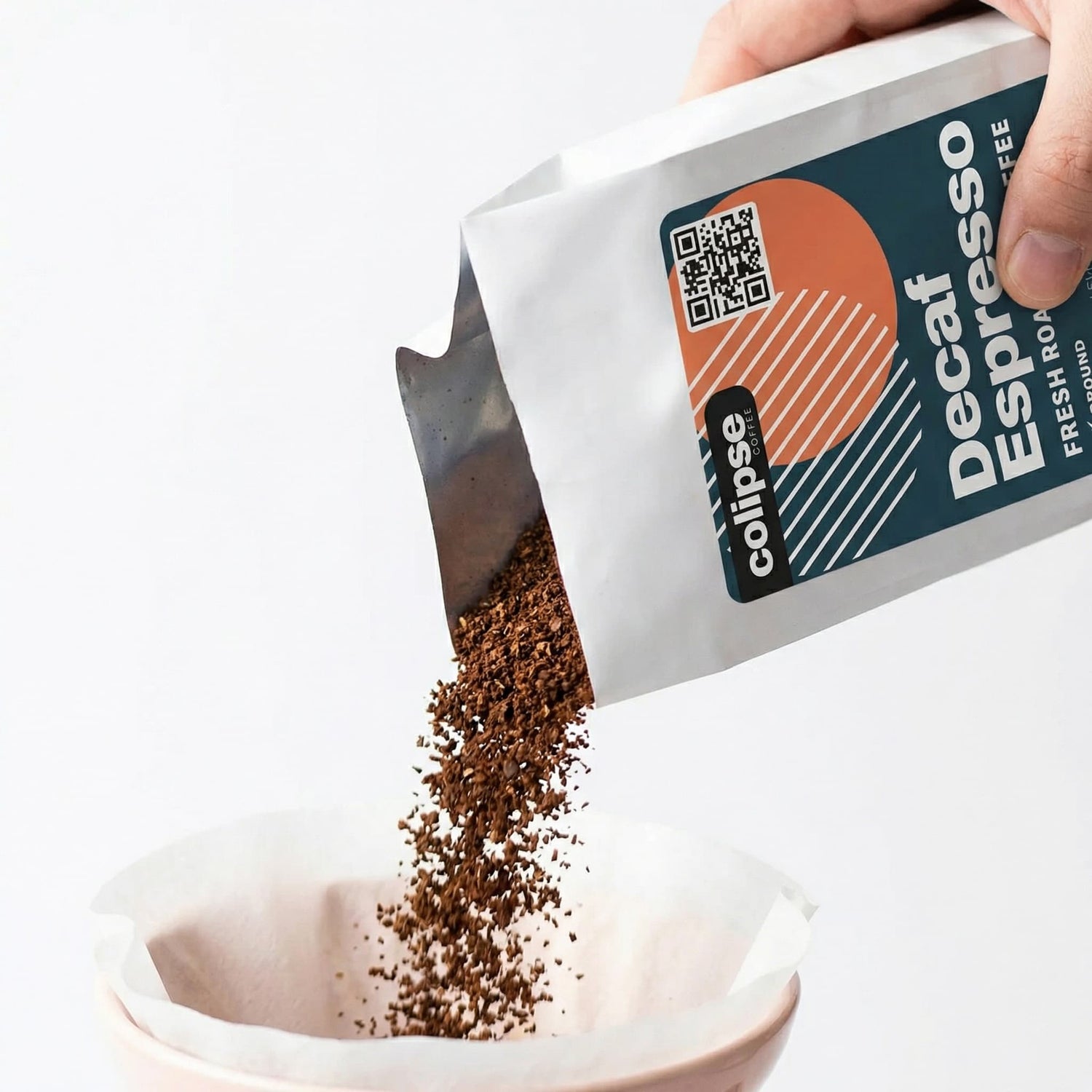 Decaf Espresso coffee being poured from a Colipse package into a white bowl.