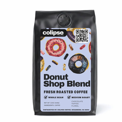 A bag of Colipse Donut Shop Blend fresh roasted coffee with an image of a glazed donut on the packaging.