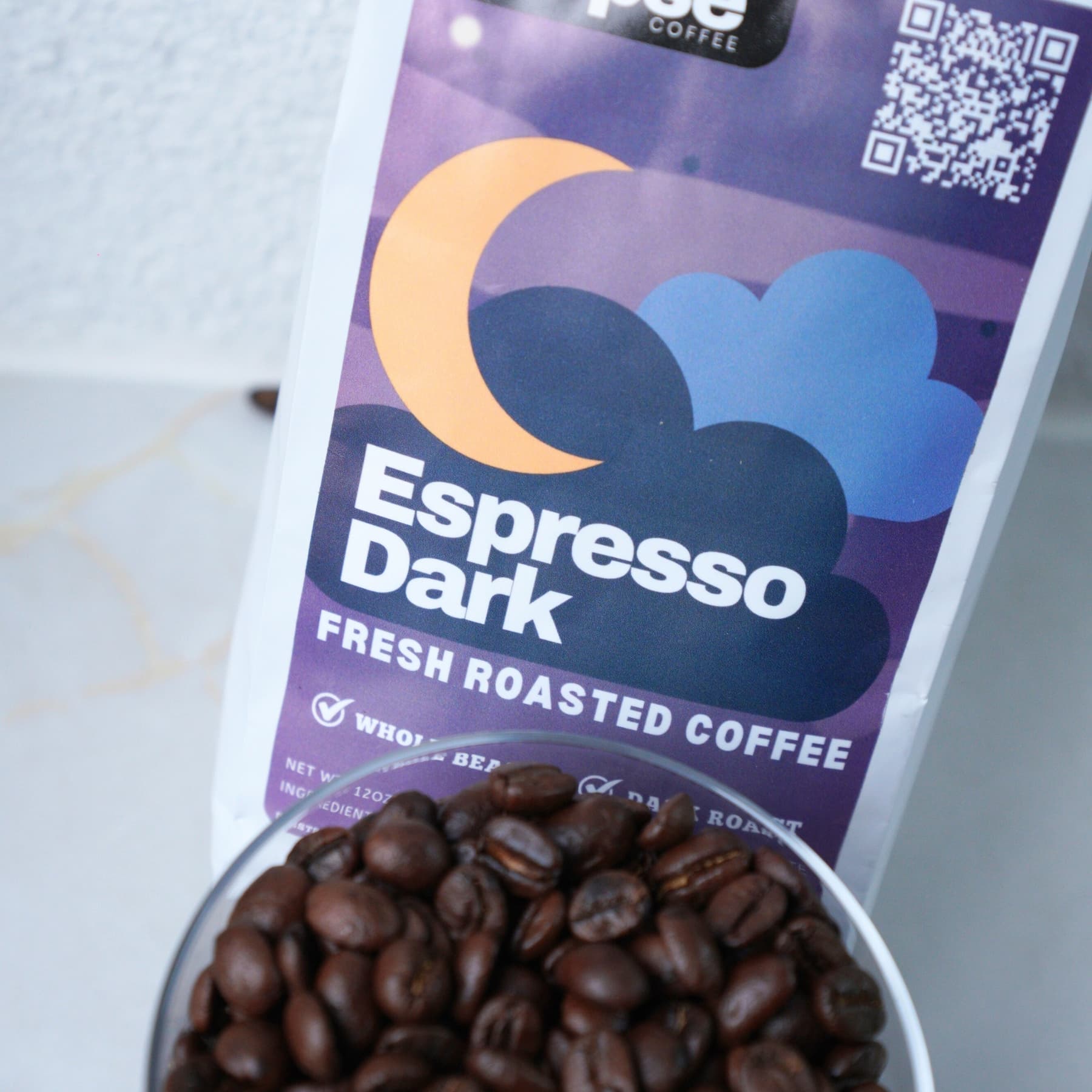 Espresso Dark coffee package with a bowl of coffee beans on a light background