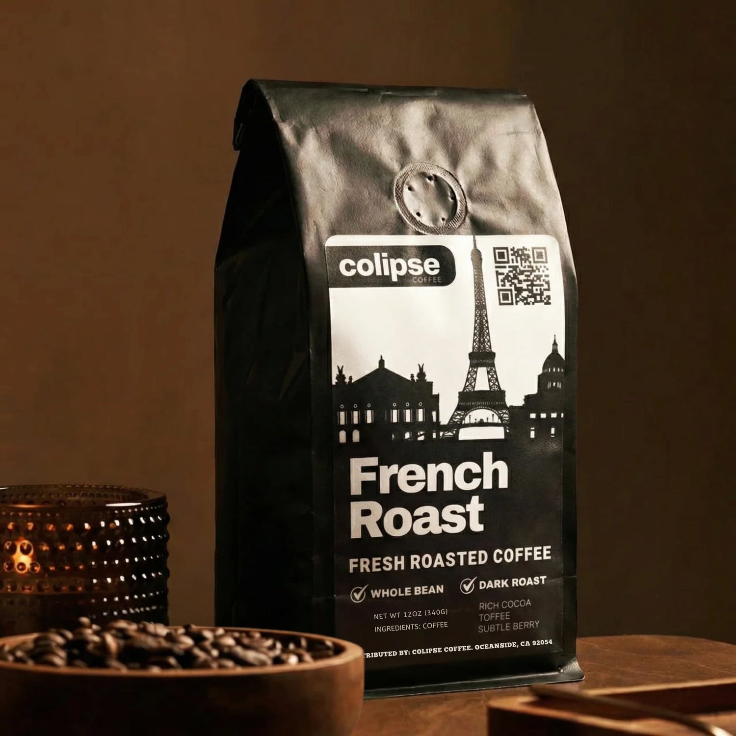 Coffee bag labeled 'colipse French Roast' with a cityscape design on a wooden surface.