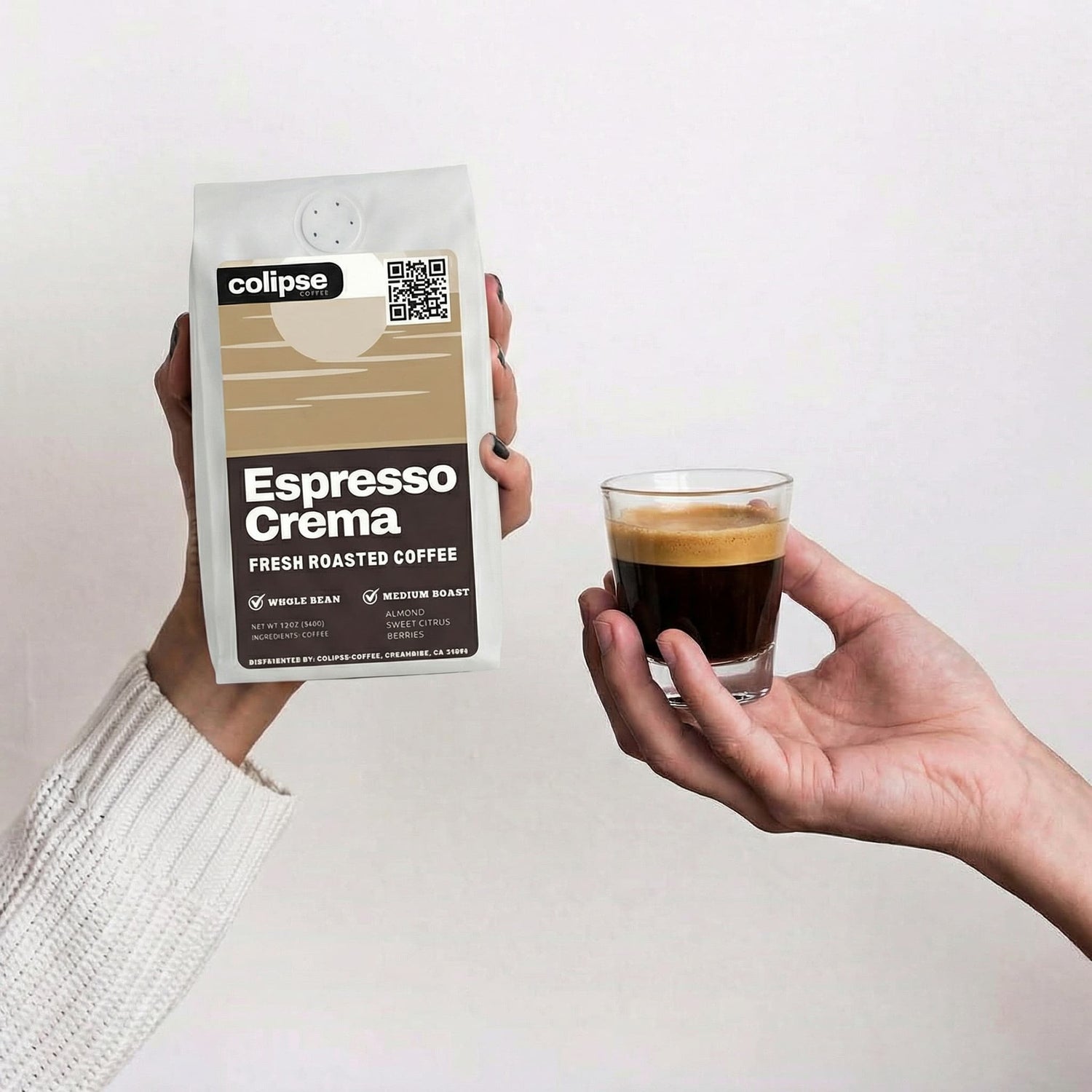 Person holding a package of colipse Espresso Crema coffee and a glass of espresso.