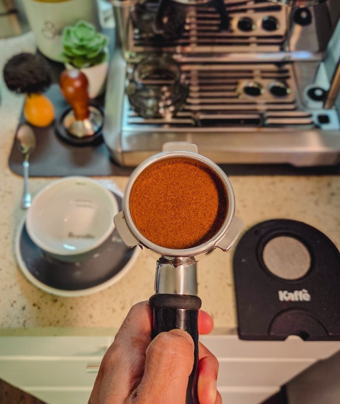Espresso being poured into two glass cups from a coffee machine.