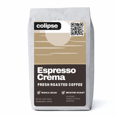 A package of Colipse Espresso Crema fresh roasted coffee beans. The bag is predominantly white with a brown section displaying the product name and additional details such as 'whole bean', 'medium roast', and flavor notes of almond, sweet citrus, and berries.