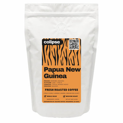 White coffee bag with an orange label featuring 'Colipse' branding and text about Papua New Guinea coffee.