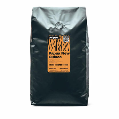 Black coffee bag with a label for Papua New Guinea coffee on a white background